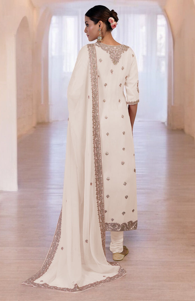 A woman from behind wears a white kurta set with rose gold embroidery.
