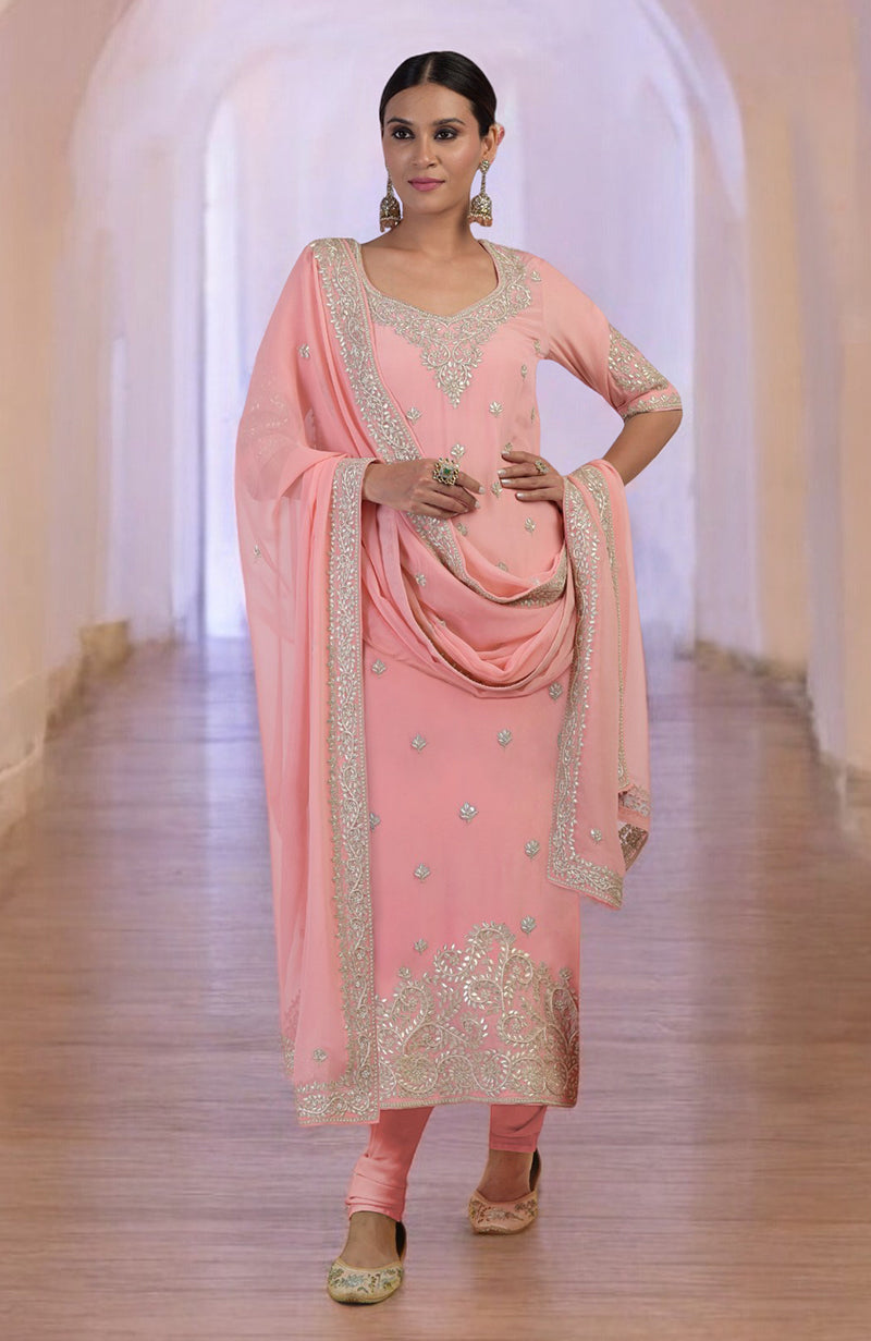 Pink kurta set with rose gold gota patti and zardozi embroidery, paired with churidar and dupatta.