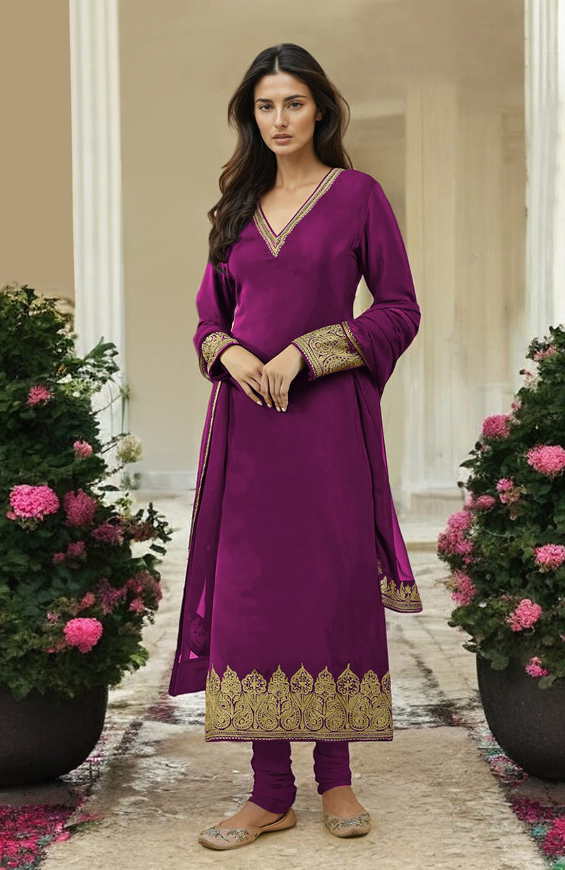 A woman models a fuchsia gold Kashmiri tilla aari embroidered kurta set.