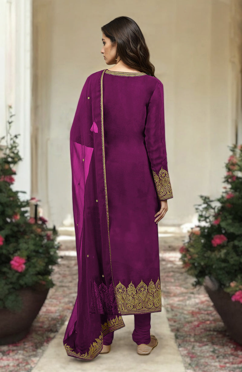 A woman from behind wears a fuchsia kurta set with gold embroidery.