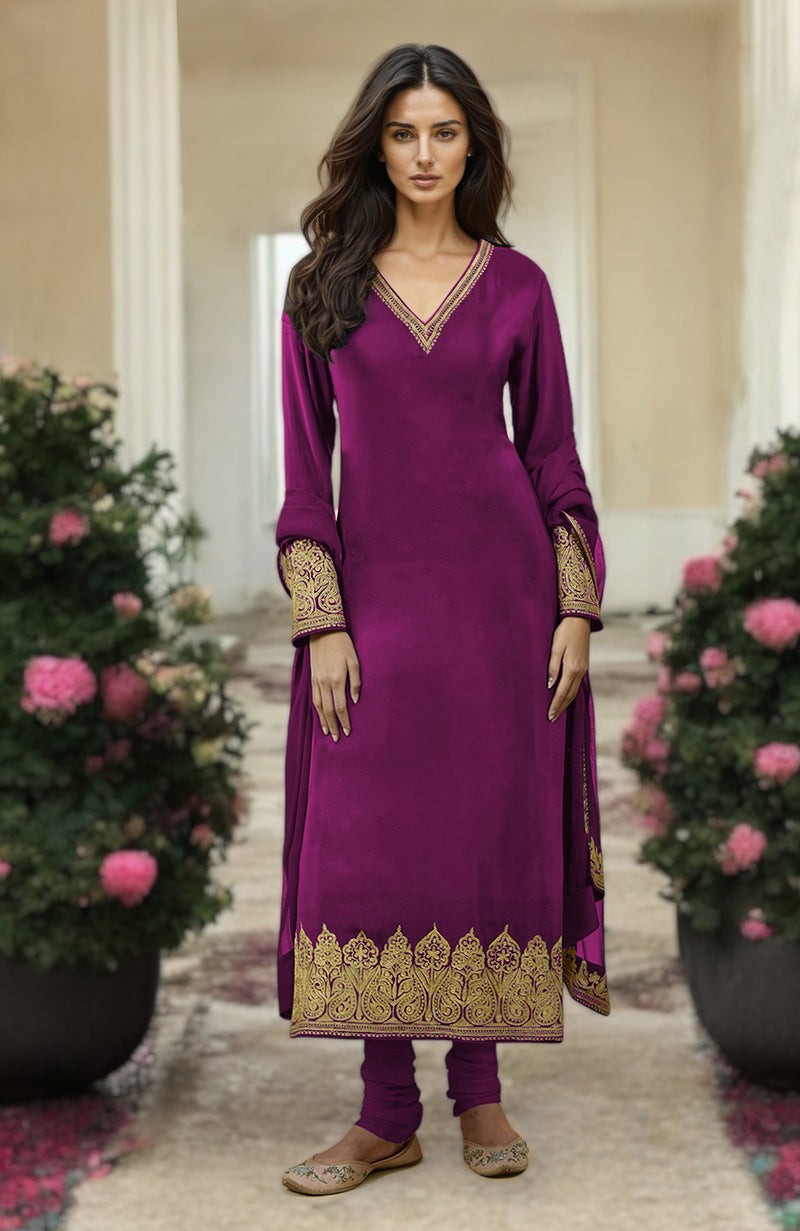 A woman models a fuchsia kurta set with gold Kashmiri tilla aari embroidery.