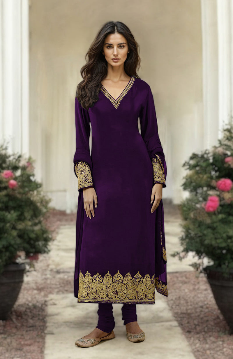 A woman models a plum gold Kashmiri Tilla Aari embroidered kurta set.
