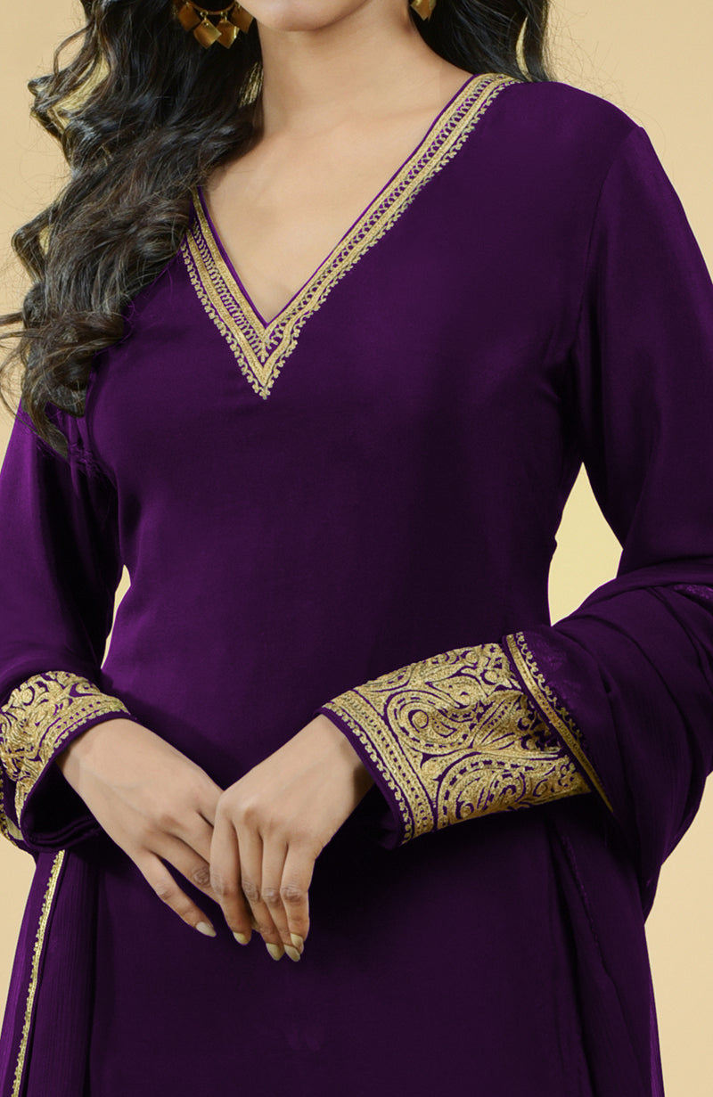 Plum gold Kashmiri tilla aari embroidered kurta set with intricate detailing.