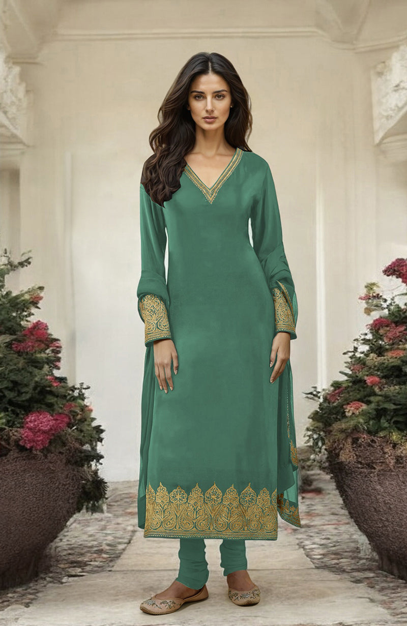 A woman models a jade green kurta set with gold Kashmiri tilla aari embroidery.