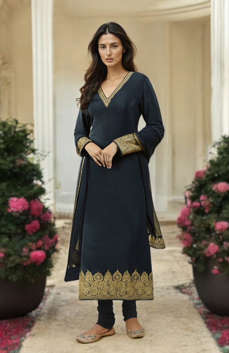 A woman models a black kurta set with gold Kashmiri tilla aari embroidery.