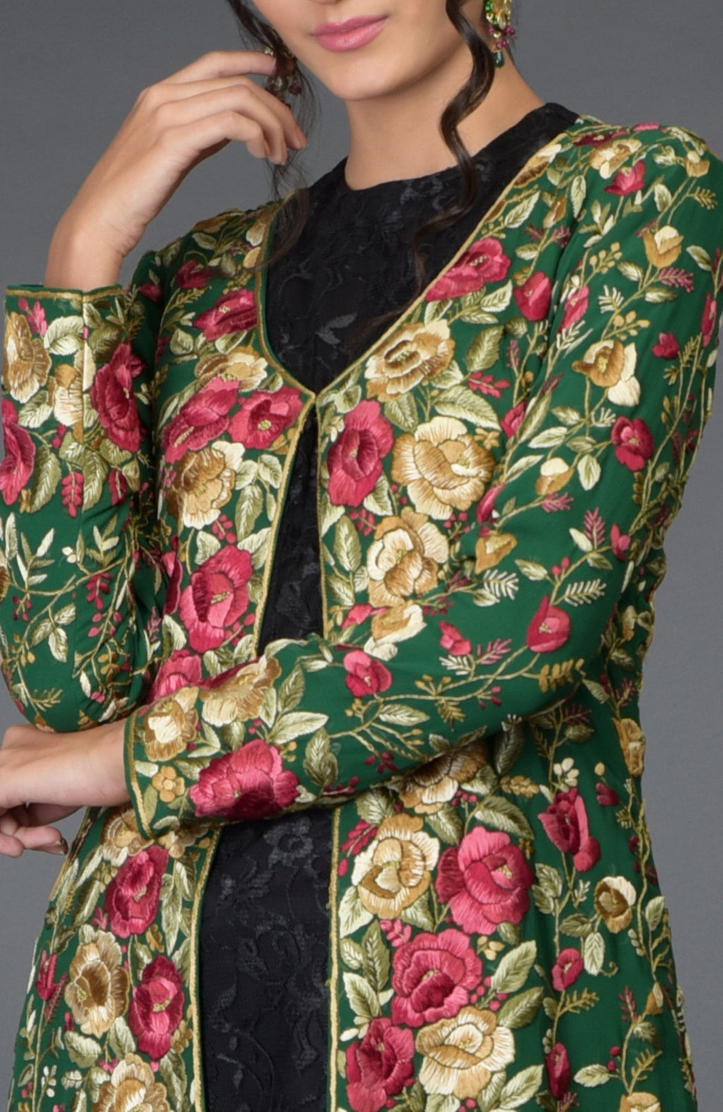 Emerald green georgette jacket with Parsi Gara floral embroidery and beige crepe flared skirt.
