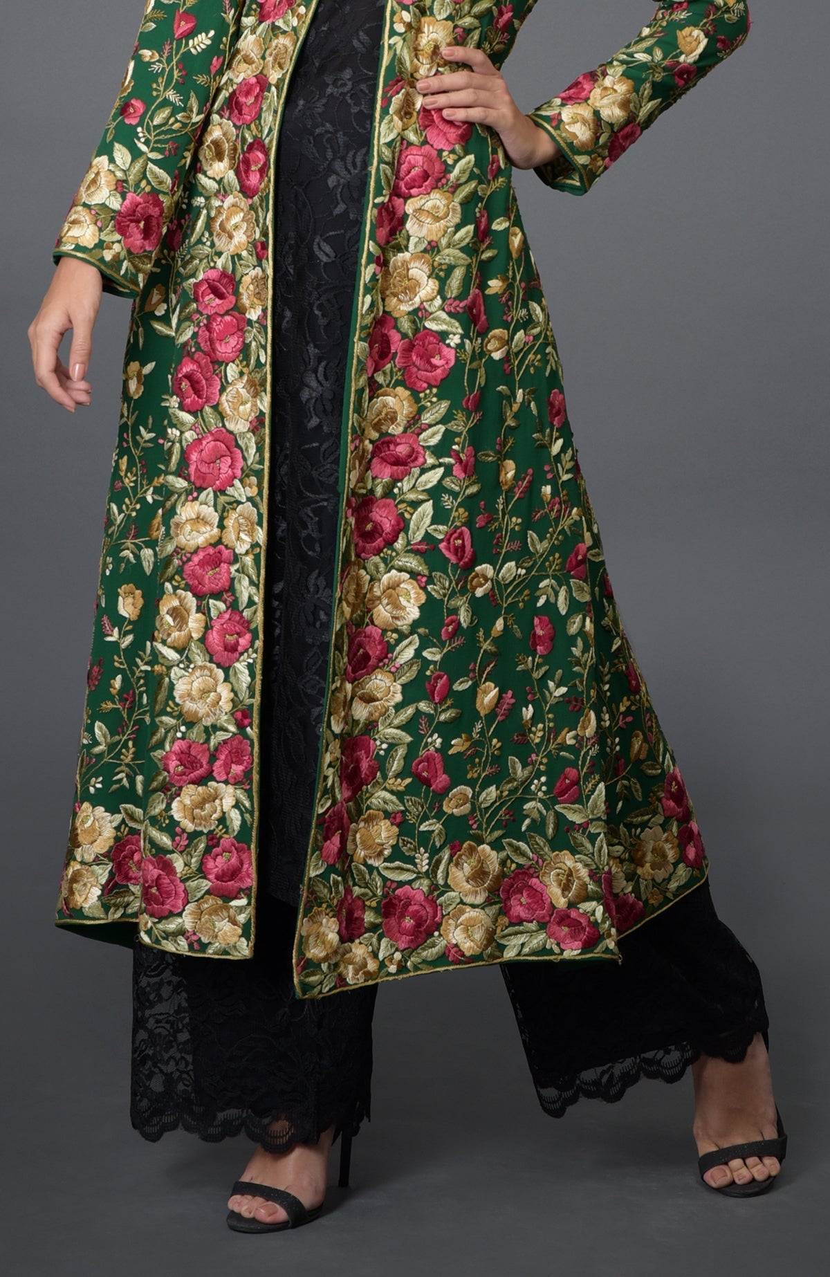 Emerald green georgette jacket with multicolor Parsi Gara floral embroidery and beige flared skirt.
