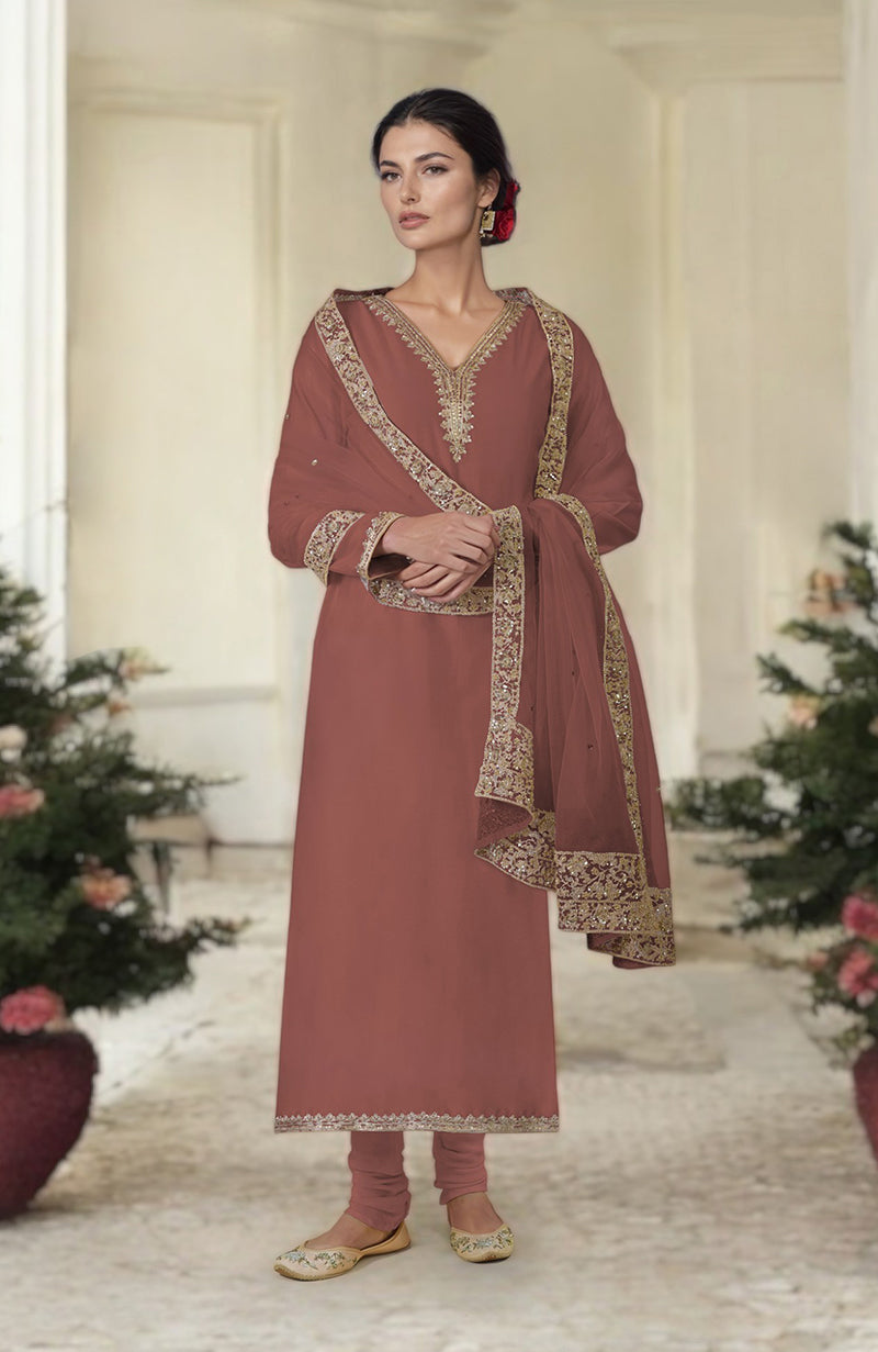 A woman models a brown kurta set with gold embroidery and a matching dupatta.