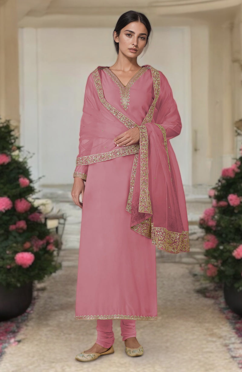 A woman models a withered rose kurta set with gold embroidery and a matching dupatta.