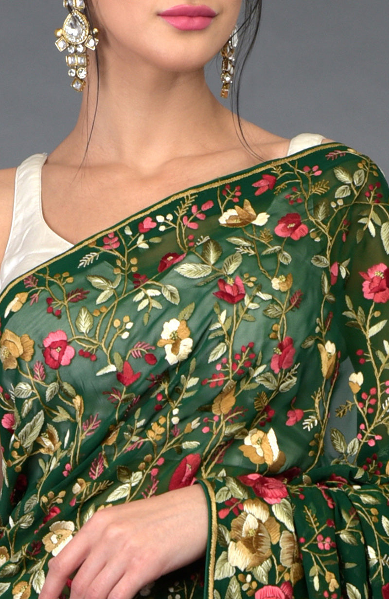 Emerald green Parsi Gara hand embroidered saree with floral patterns.