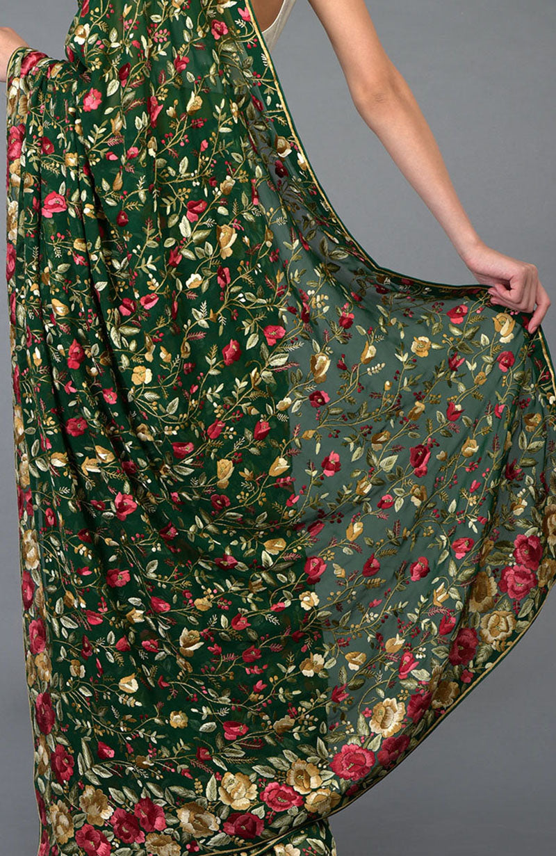 Emerald green Parsi Gara hand-embroidered saree with floral borders and jaal.
