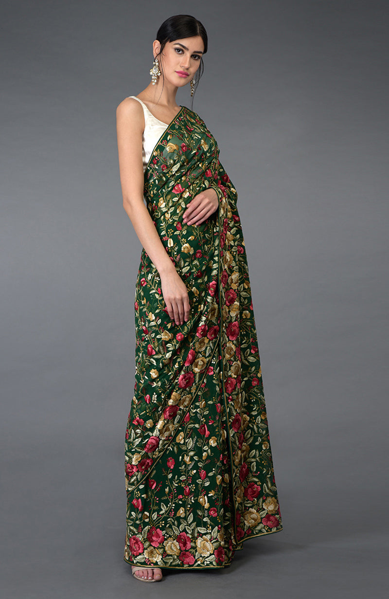 Emerald green Parsi Gara hand embroidered saree with floral patterns.