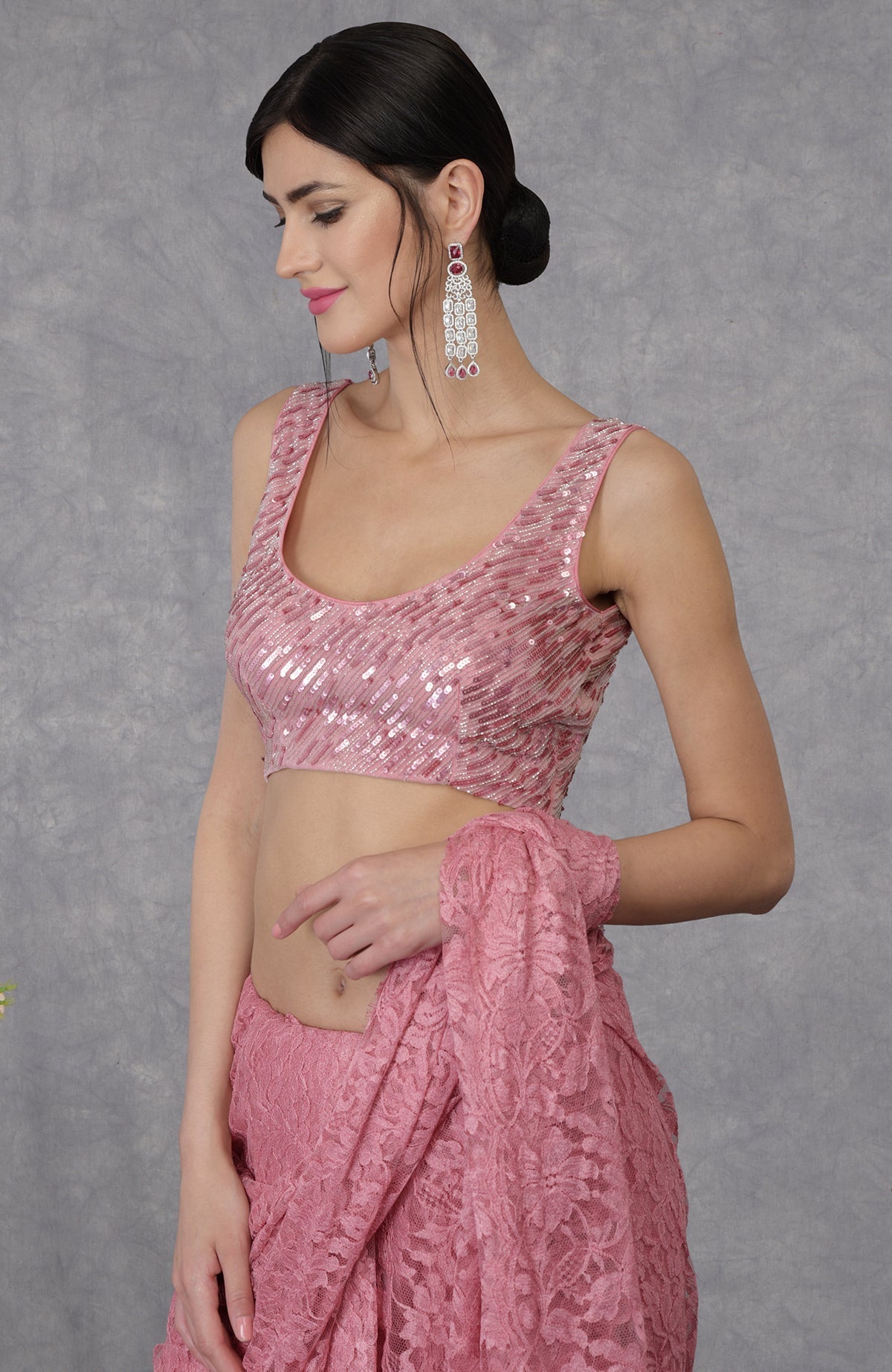 Pressed rose sequin and beads hand embroidered blouse with a matching lace saree.