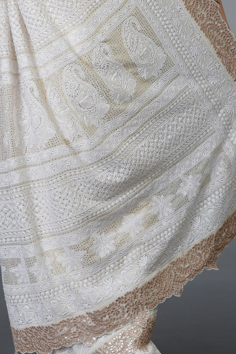 Ivory Georgette saree with hand-embroidered Chikankari, gold kamdani, and rose gold gota patti borders.