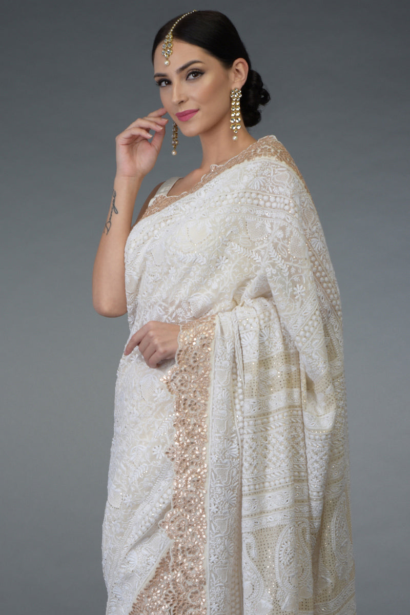 Ivory Georgette saree with hand-embroidered Chikankari, gold kamdani, and rose gold gota patti borders.