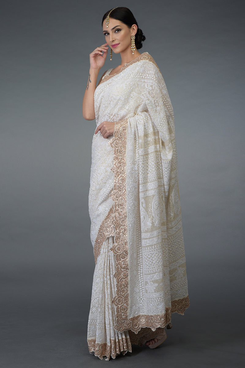 Ivory Georgette saree with intricate Chikankari, antique gold kamdani, and rose gold gota patti embroidery.