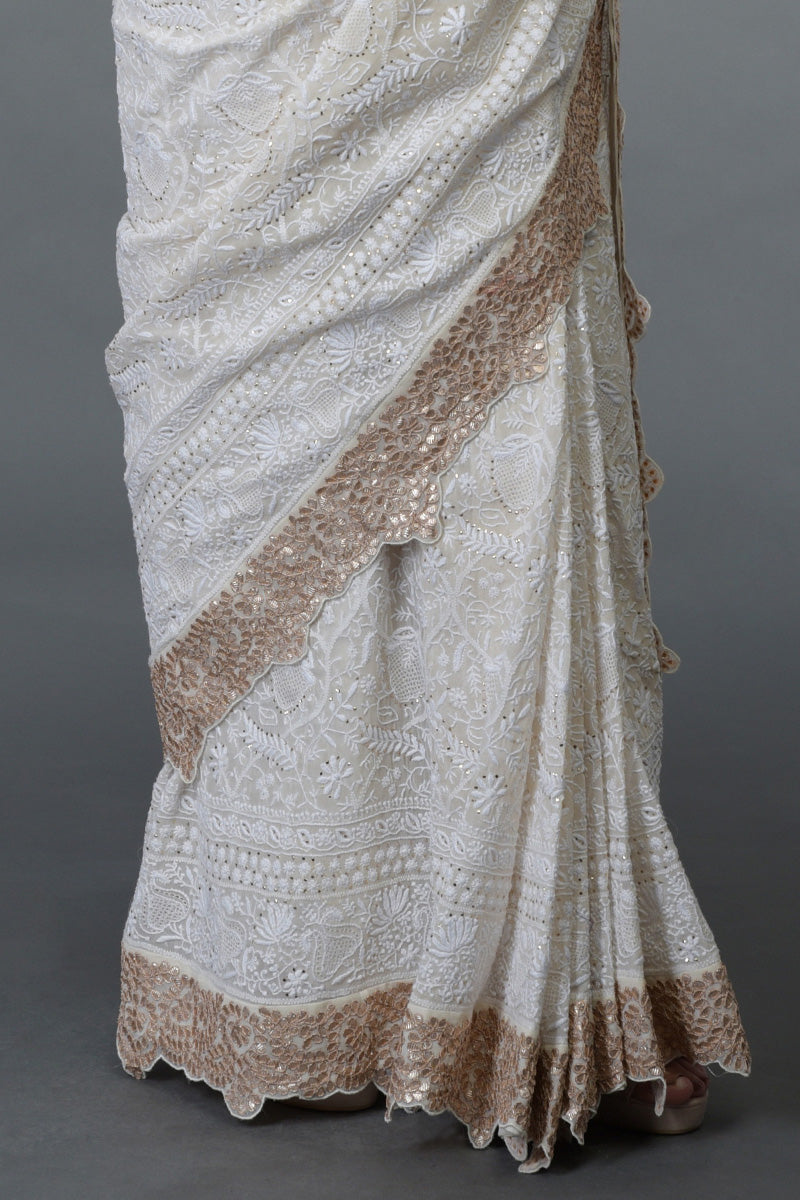 Ivory Georgette saree with hand-embroidered Chikankari, gold kamdani, and rose gold gota patti borders.