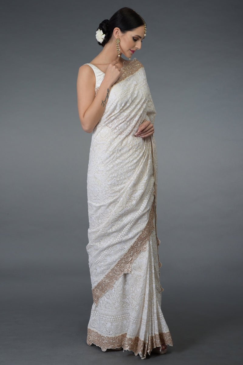 Ivory Georgette saree with hand-embroidered Chikankari, gold kamdani, and rose gold gota patti borders.