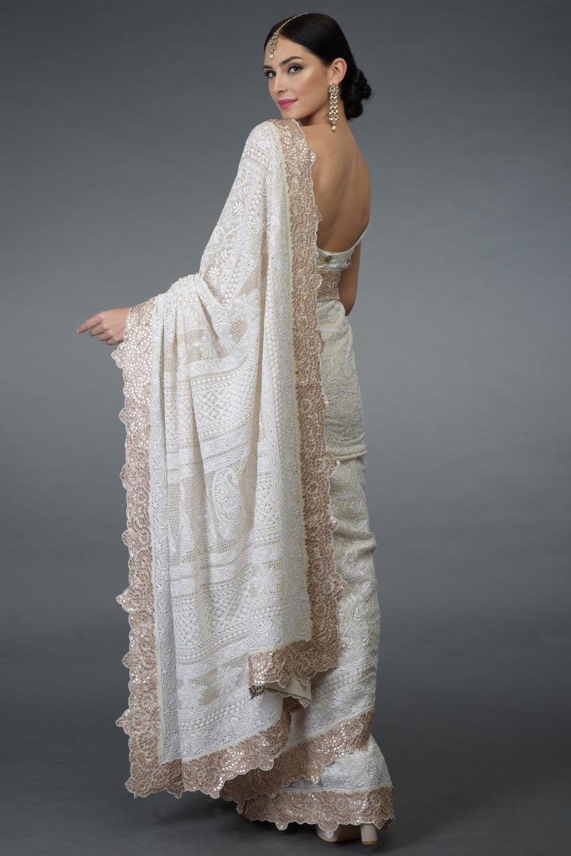 Ivory Georgette saree with intricate Chikankari, antique gold kamdani, and rose gold gota patti borders