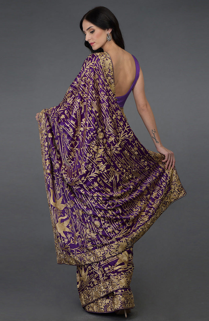 Purple satin silk saree with beige hand embroidered birds and floral Parsi Gara borders.