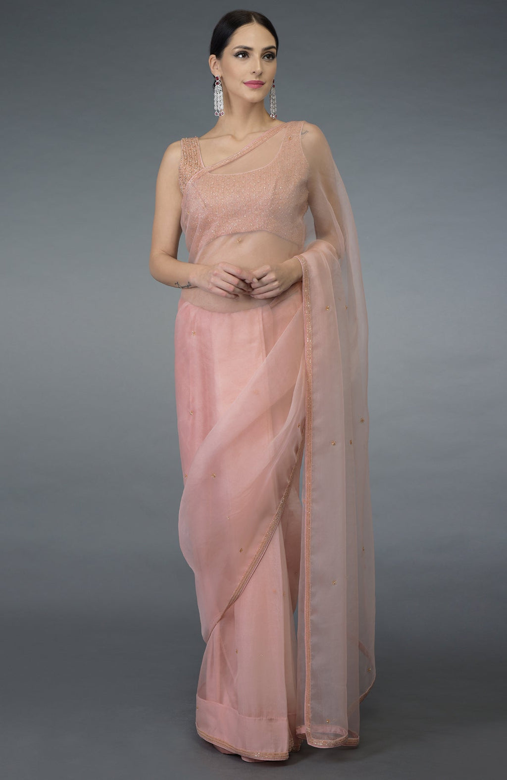 Pastel peach organza silk saree with a hand-embroidered blouse.