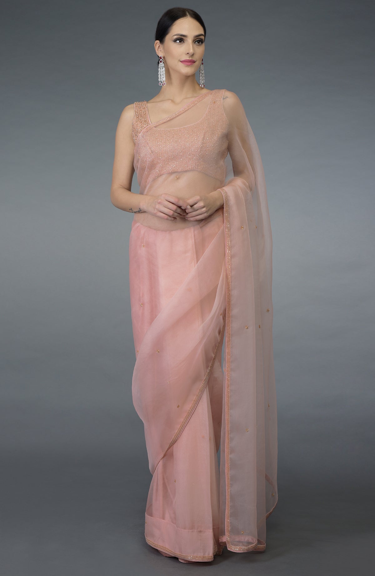 Pastel peach organza silk saree with a hand-embroidered blouse.