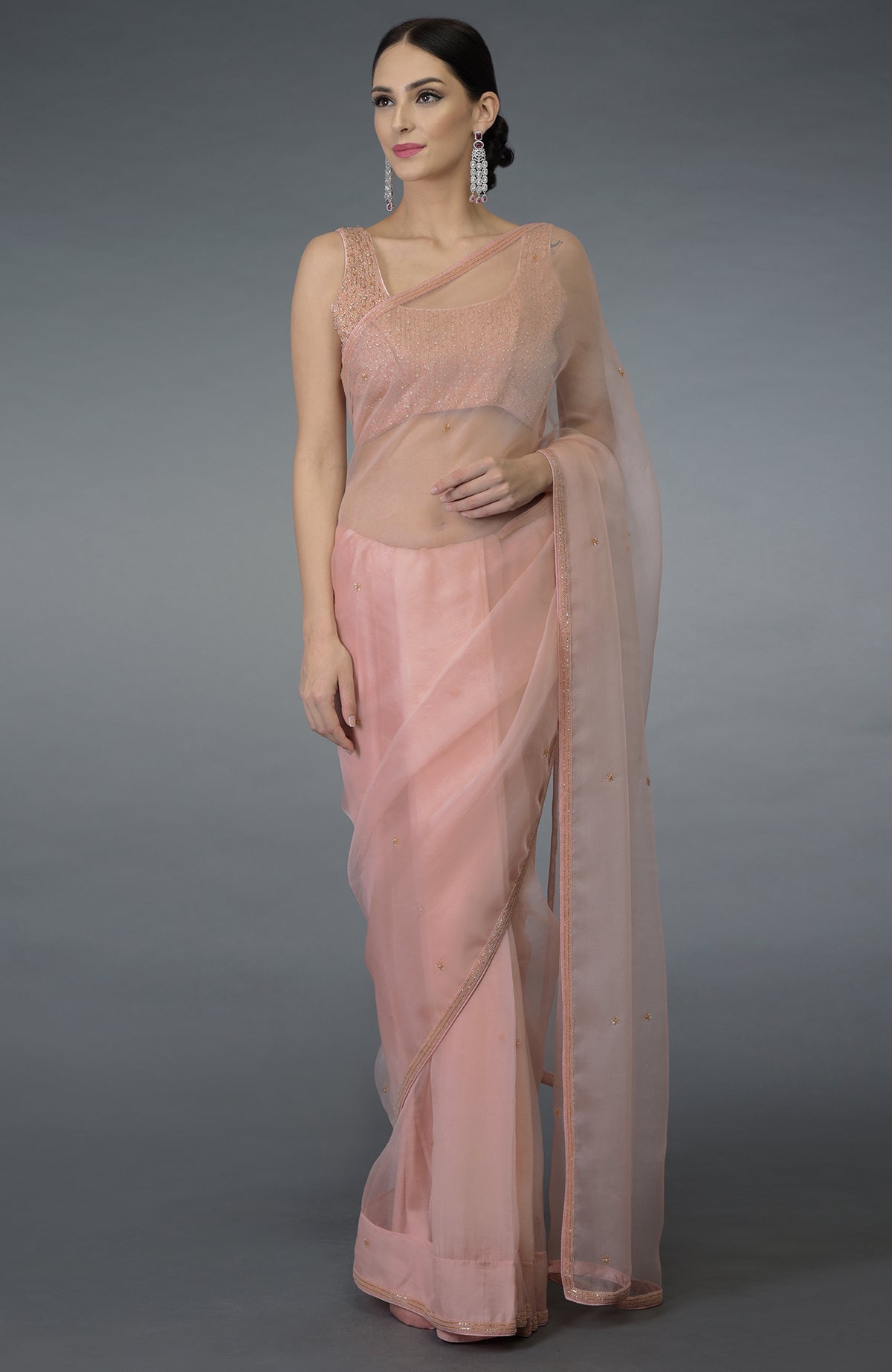 Pastel peach organza silk saree with a hand-embroidered blouse.