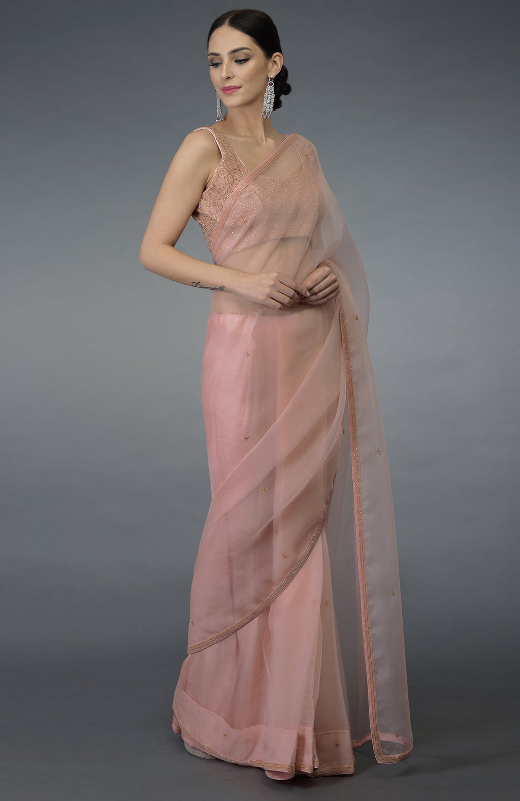 Pastel peach organza silk saree with a hand-embroidered blouse.