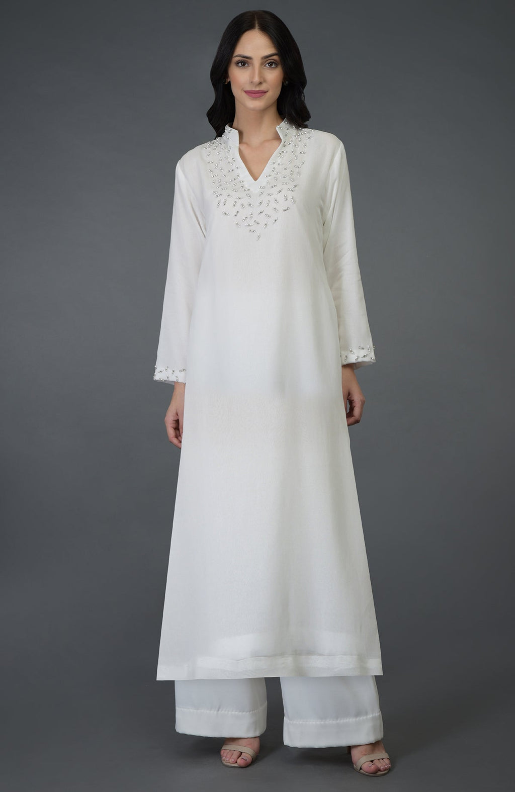 Off-white kurta set with crystal and pearl bead embroidery on the neckline and sleeves.