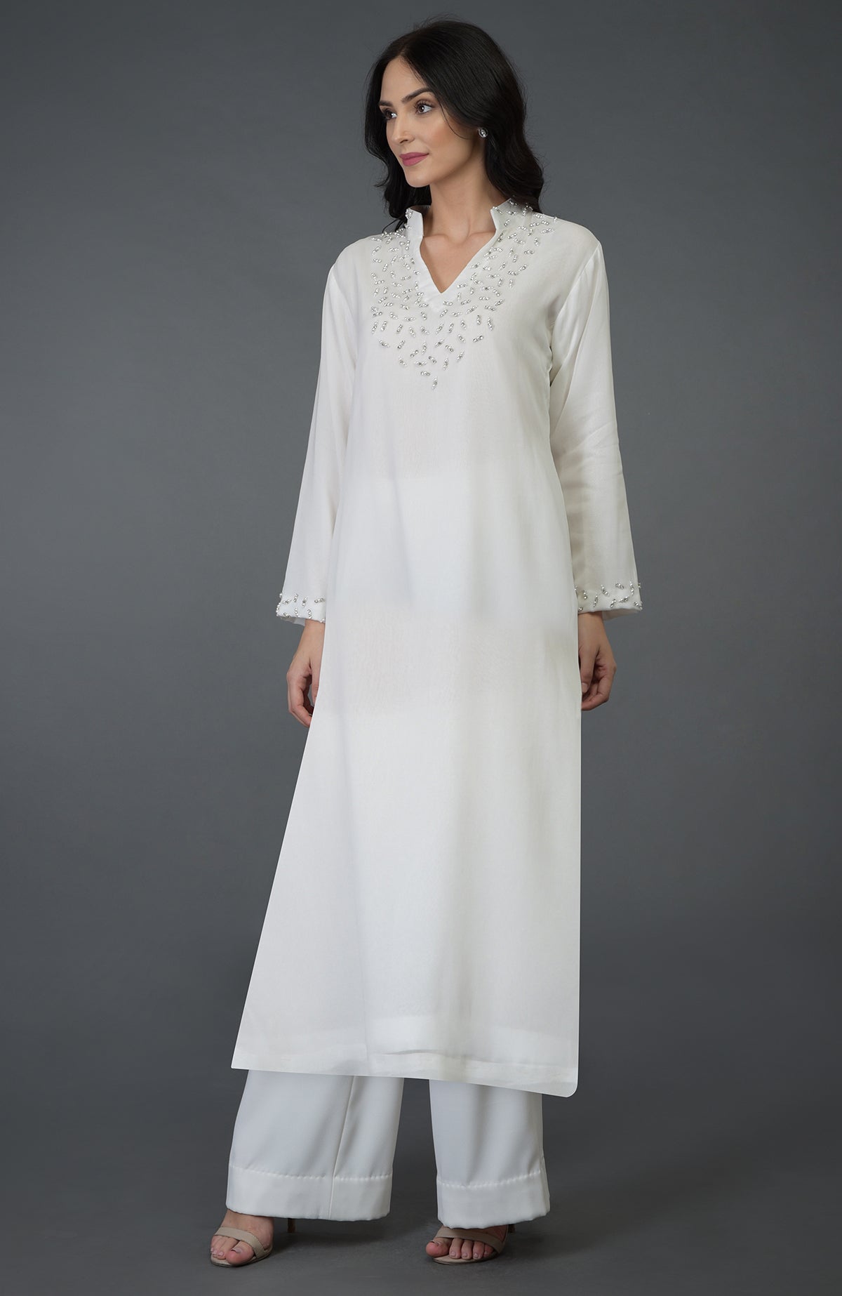 Off white kurta set with crystal and pearl bead embroidery on the yoke and sleeves.