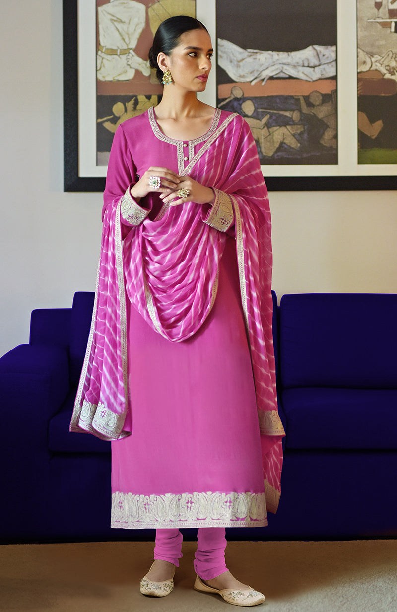 A woman models a lavender kurta set with a tie-dye dupatta and embroidered details.