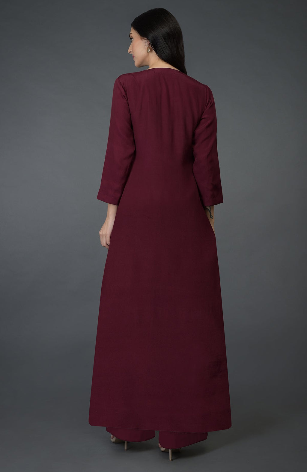 A woman from behind wears a burgundy kurta set with wide-leg palazzo pants.