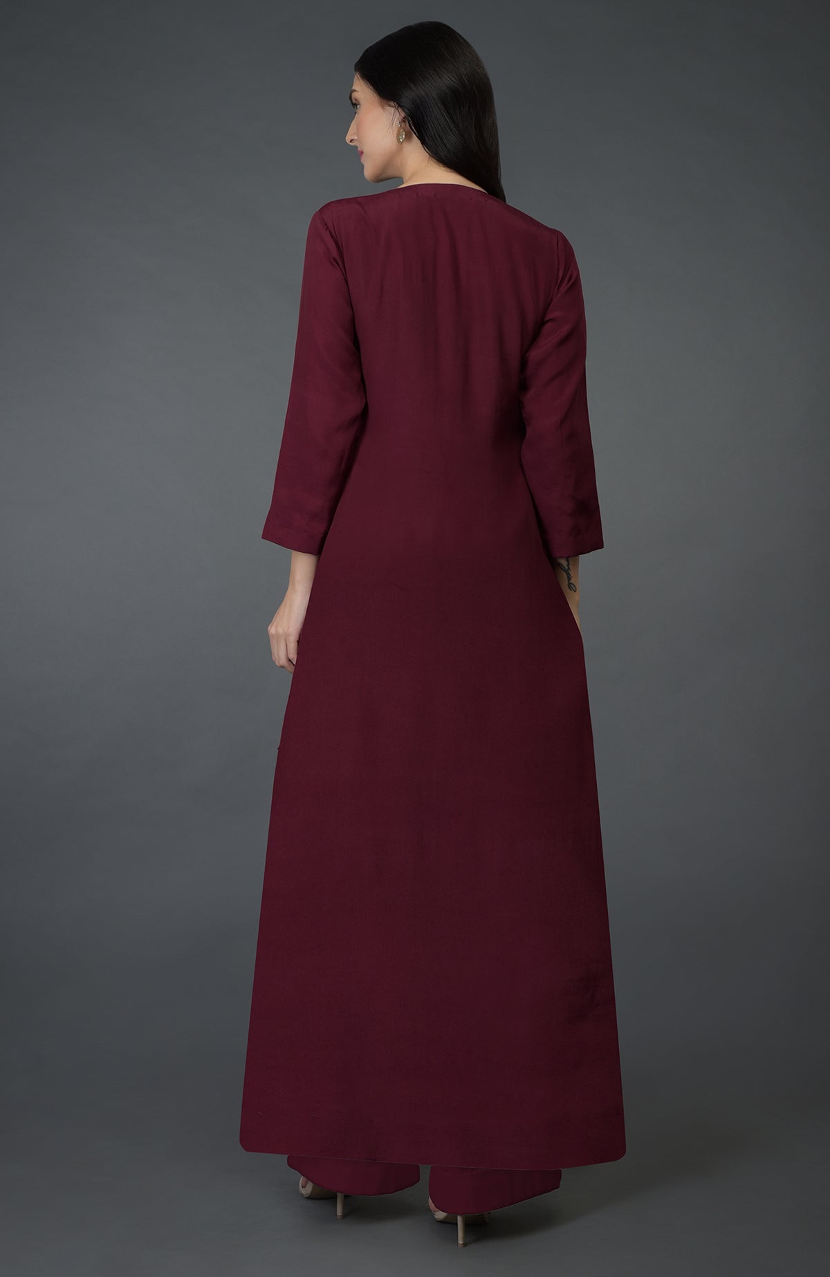 A woman from behind wears a burgundy kurta set with wide-leg palazzo pants.