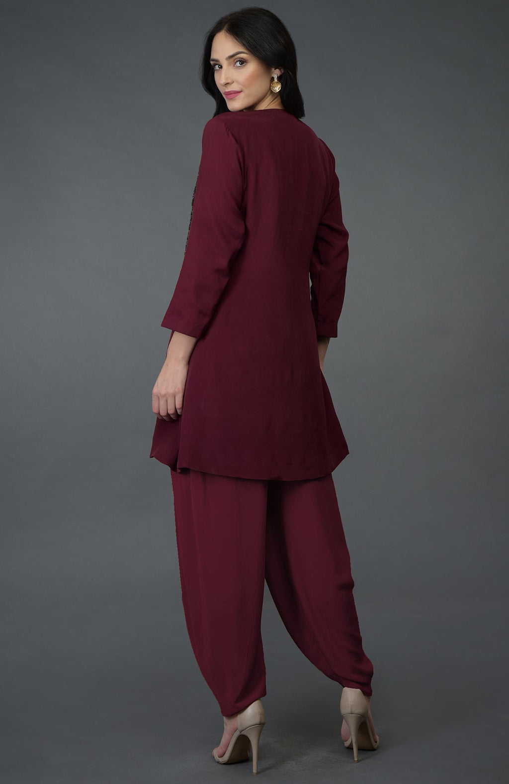 A woman models a burgundy resham sequin and beads embroidered dhoti pants suit.