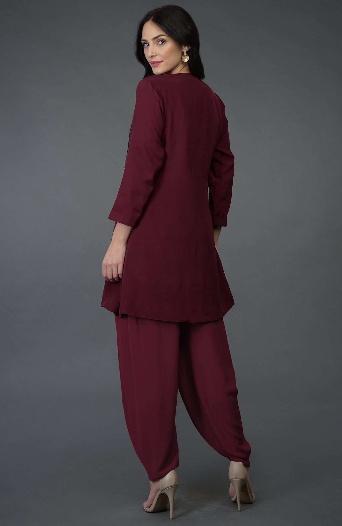 A woman models a burgundy resham sequin and beads embroidered dhoti pants suit.