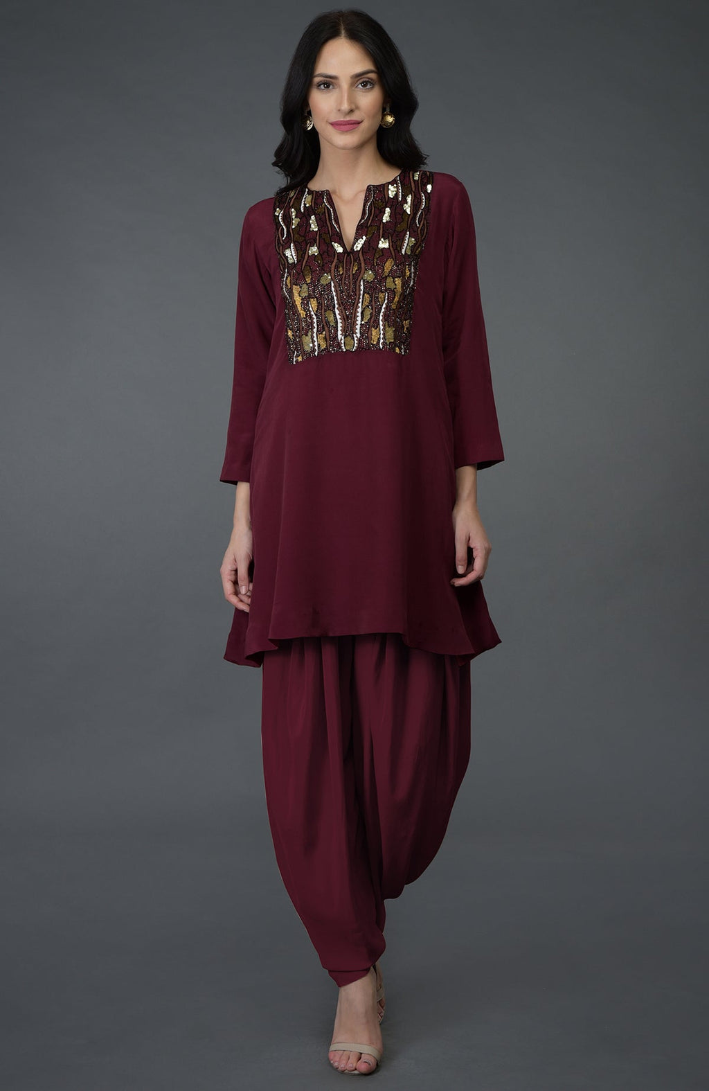 A woman models a burgundy resham sequin and beads embroidered dhoti pants suit.