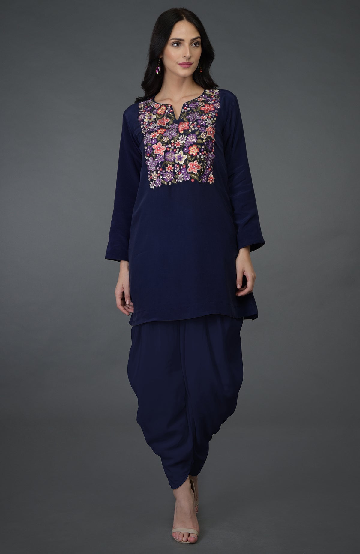A woman models an eclipse blue resham sequin and beads work top with dhoti pants.