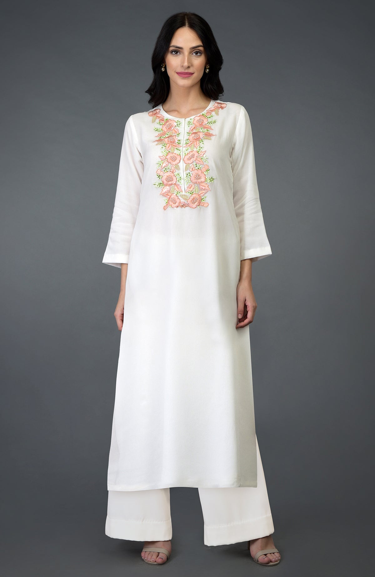 An ivory kurta set with peach and green floral embroidery on the yoke.