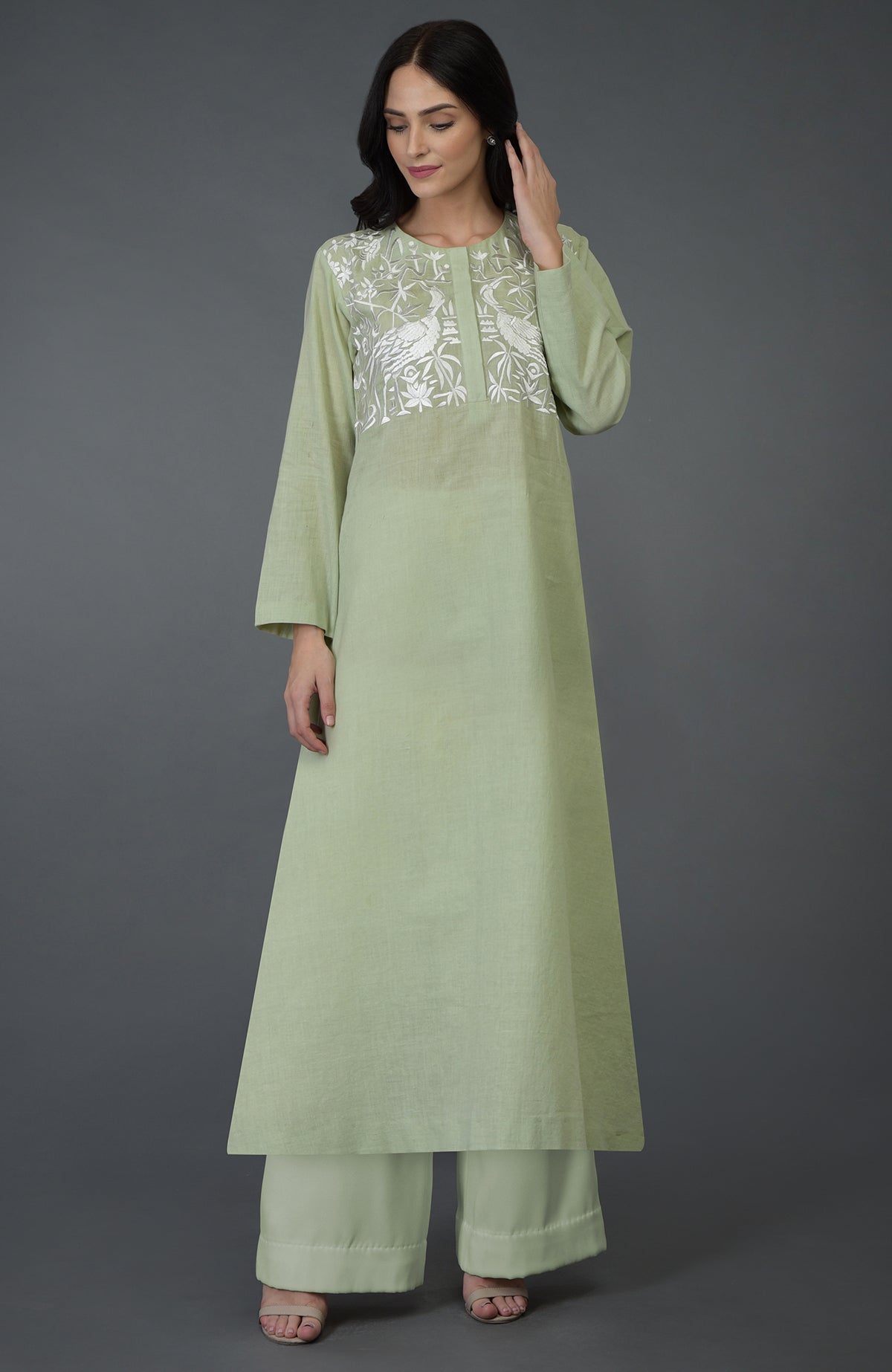 Pista green kurta set with white birds and floral embroidery on the yoke.