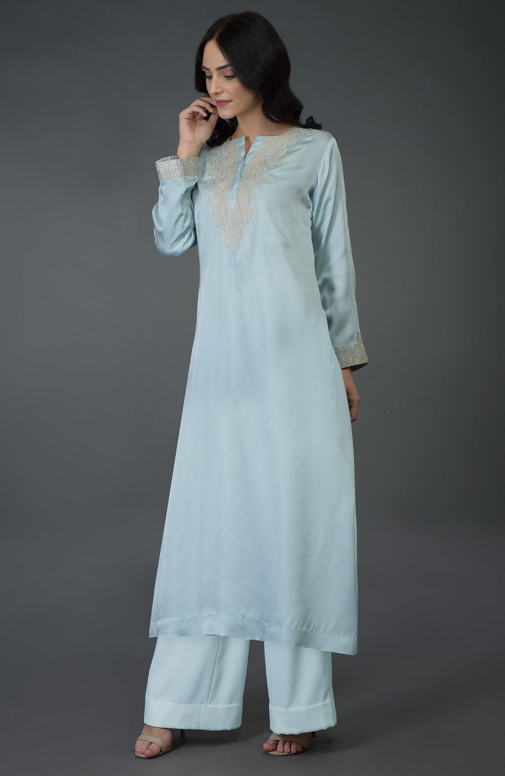 A woman models a serenity blue Kashmiri tilla embroidered kurta set.
