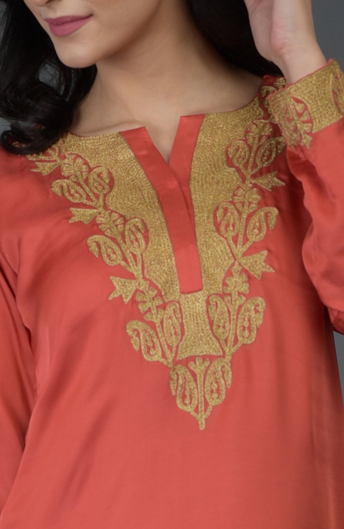 Living coral kurta with gold Kashmiri tilla embroidery on the neckline and sleeves.