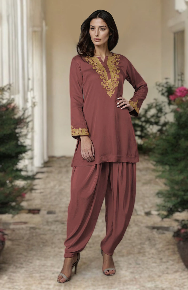 A woman models a chutney-colored dhoti pants suit with gold Kashmiri tilla embroidery.
