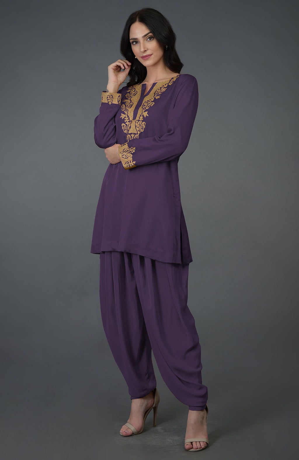 A woman models a mulled grape Kashmiri tilla embroidered dhoti pants suit.