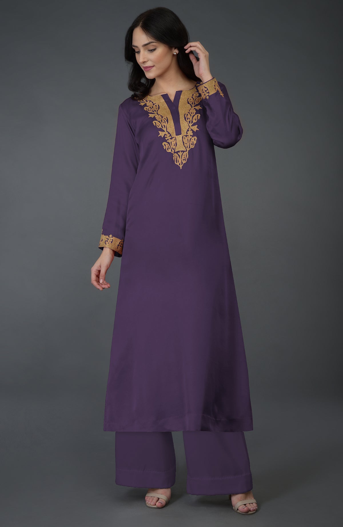 A woman models a mulled grape Kashmiri tilla embroidered kurta set.