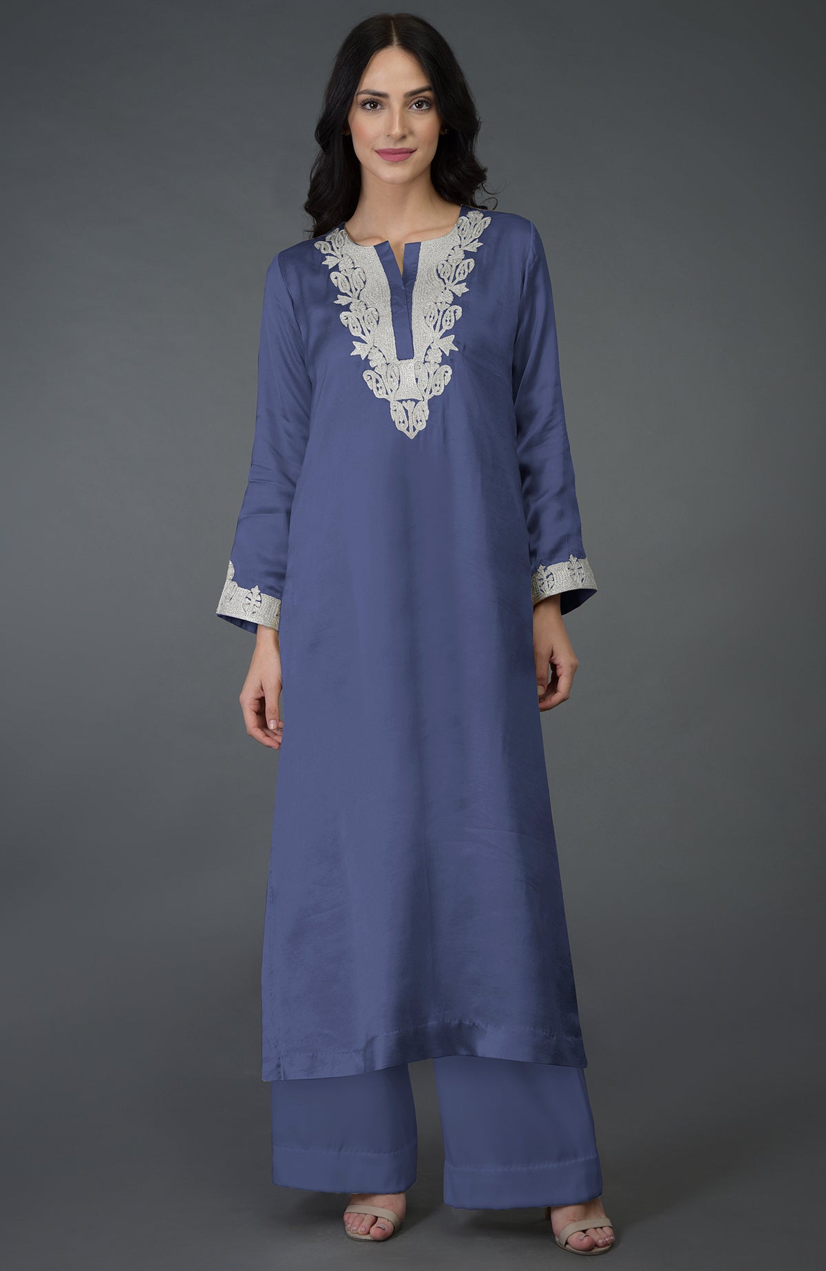 An Iris Blue Kashmiri Tilla Embroidered Kurta Set with a woman modeling it.