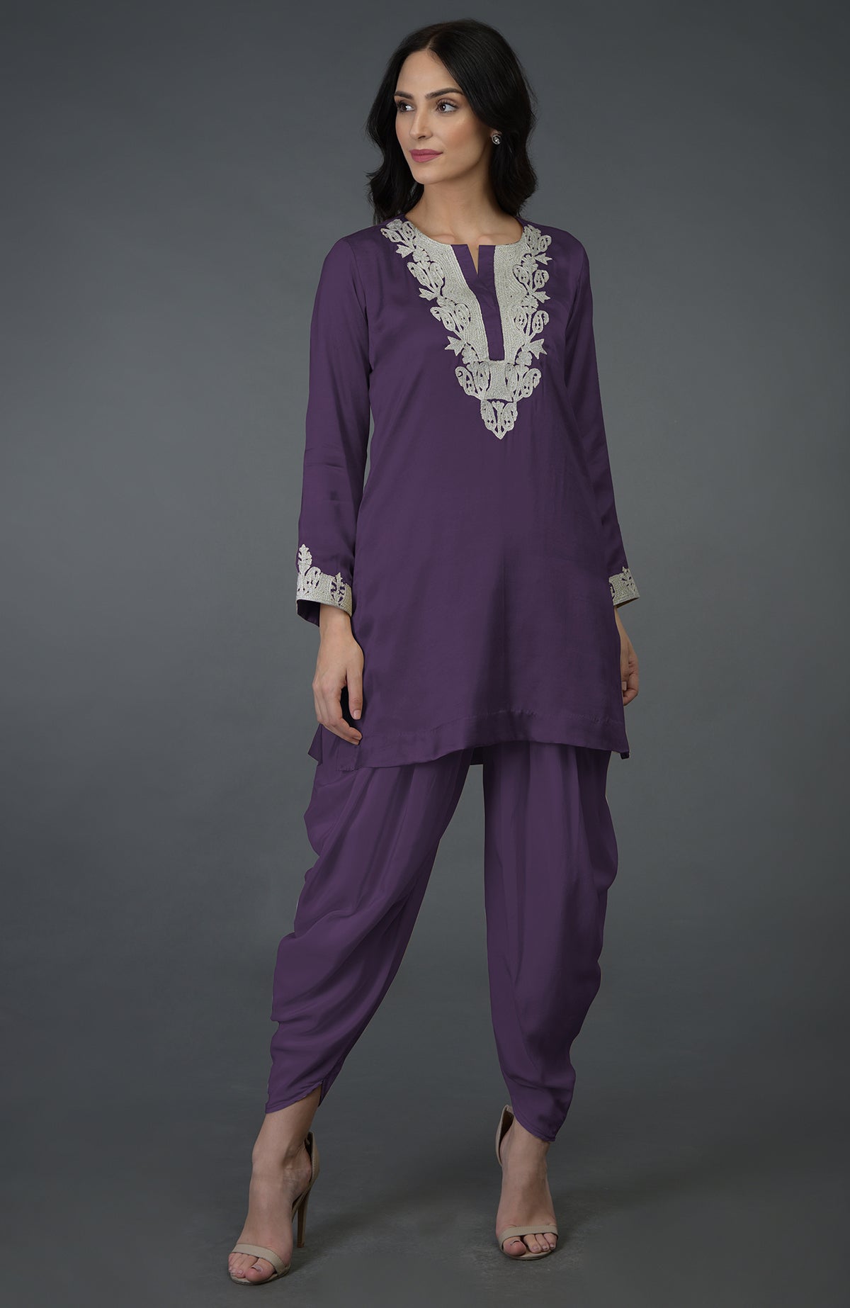A woman models a mulled grape Kashmiri tilla embroidered dhoti pants suit.