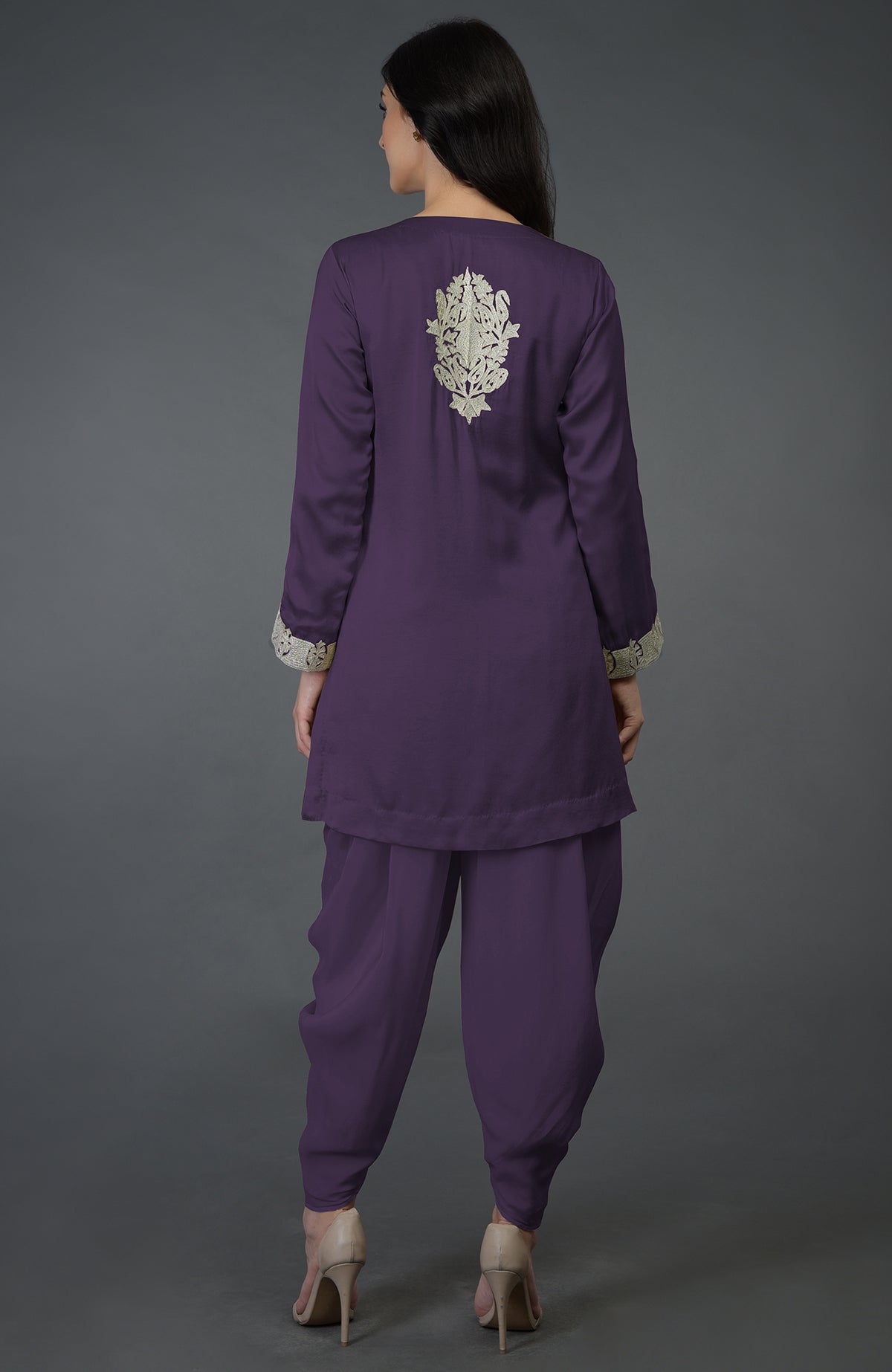 A woman from behind wears a mulled grape Kashmiri tilla embroidered dhoti pants suit.