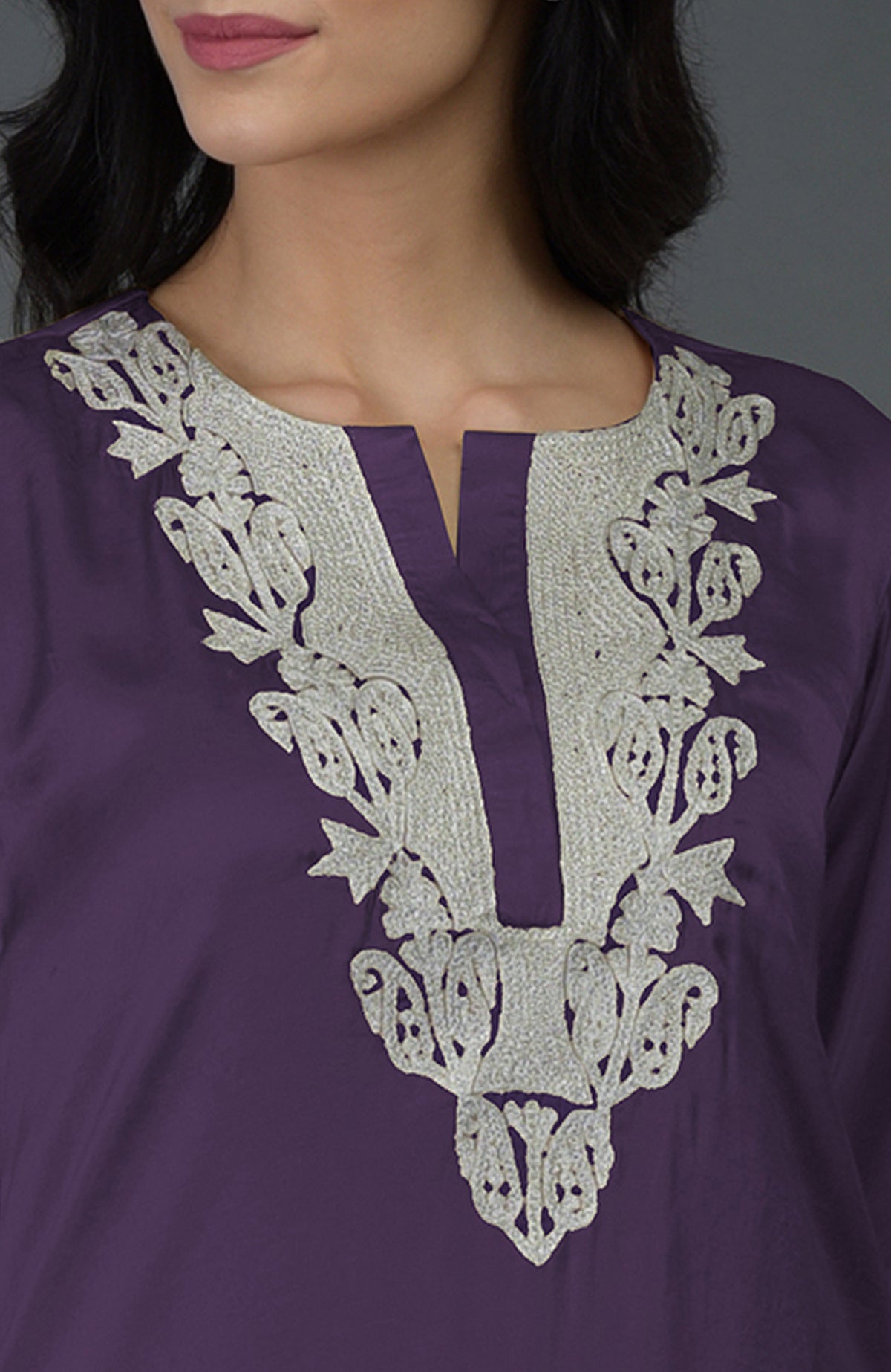 A woman models a mulled grape Kashmiri tilla embroidered dhoti pants suit.