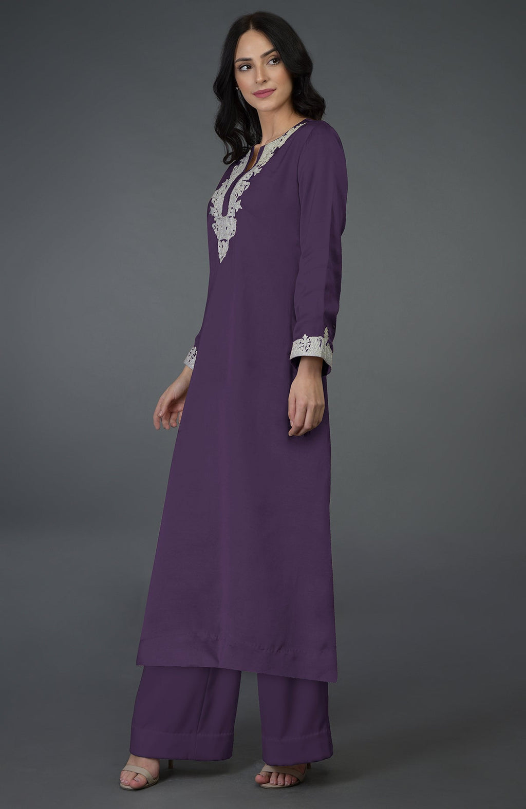 A woman models a mulled grape Kashmiri tilla embroidered kurta set.
