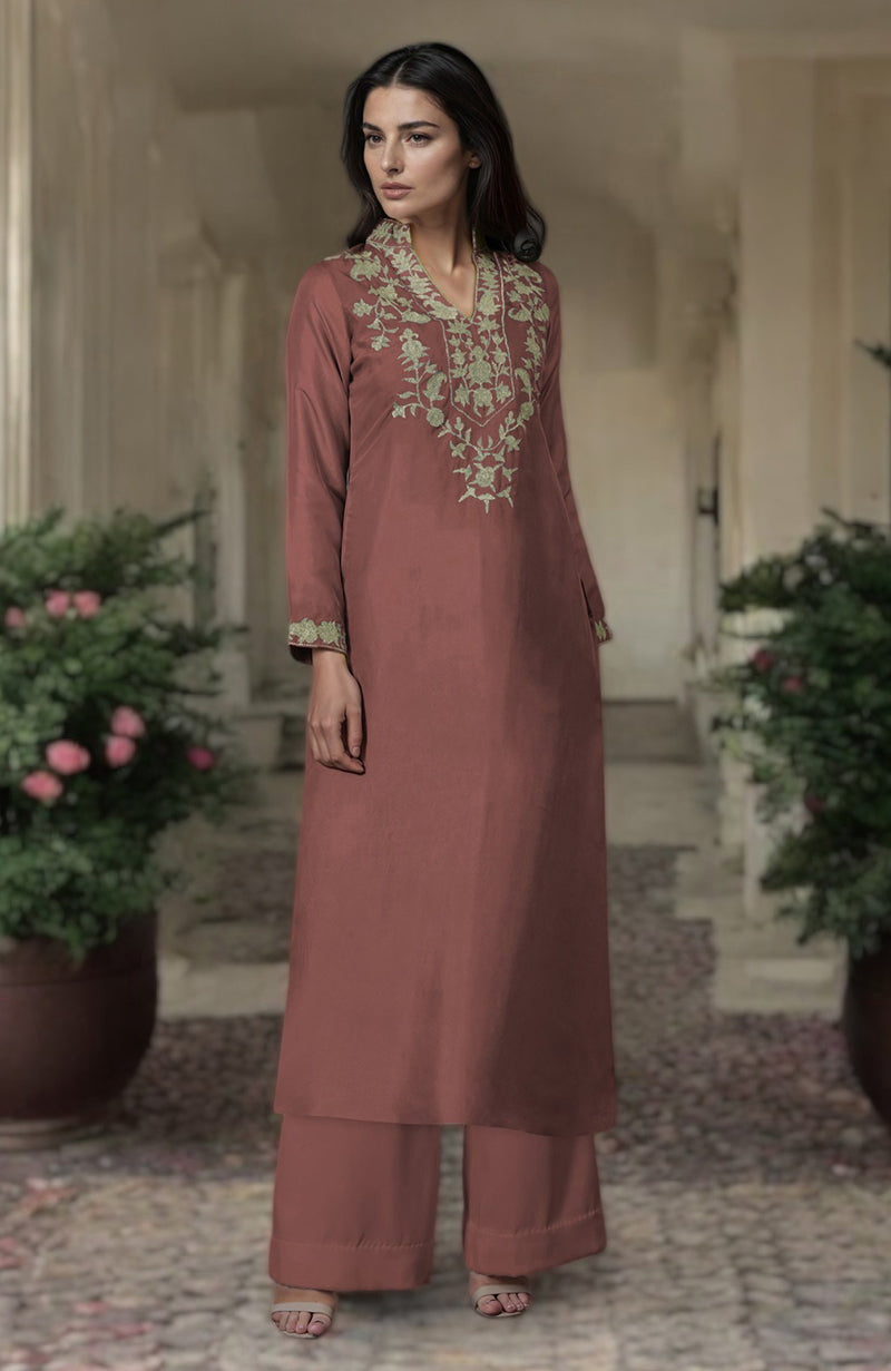 A woman models a chutney-colored kurta set with silver Kashmiri tilla embroidery.